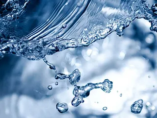 Spritzendes Wasser, das Taufe und neues Leben symbolisiert.