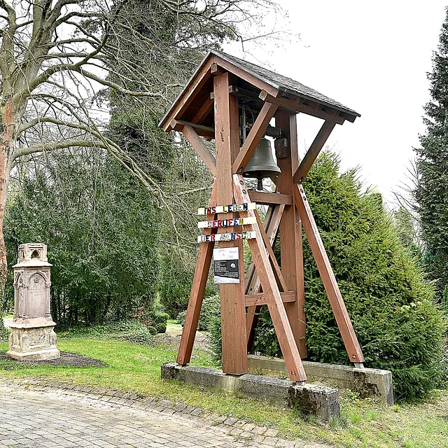 Eine alte Glocke auf dem Friedhof der Kirchengemeinde.