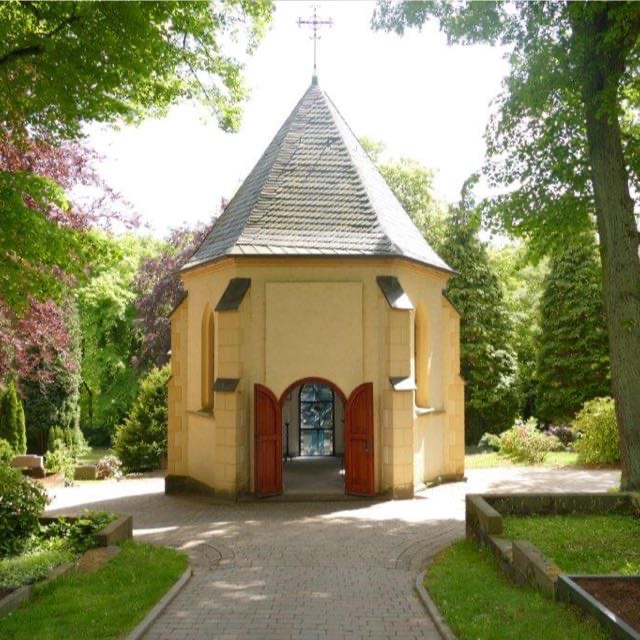 Kleine Kapelle in einer friedlichen, grünen Umgebung.